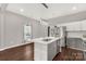 Modern kitchen with island, stainless steel appliances, and hardwood floors at 138 Pinckney St, Chester, SC 29706