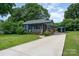 Newly renovated blue house with a front porch and landscaped lawn at 1512 Herrin Ave, Charlotte, NC 28205