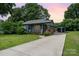 Charming renovated blue house with a front porch and landscaped lawn at 1512 Herrin Ave, Charlotte, NC 28205