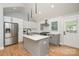 Modern kitchen with island, stainless steel appliances, and white shaker cabinets at 1512 Herrin Ave, Charlotte, NC 28205