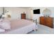 Main bedroom with a pink duvet cover and wood dresser at 195 Hidden Lakes Rd, Statesville, NC 28677