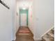 Bright and airy entryway with wood floors and teal accent wall at 195 Hidden Lakes Rd, Statesville, NC 28677
