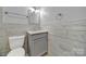 Updated bathroom with gray vanity and wood-look tile at 206 Hunter St, York, SC 29745