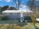Ranch style home with gray exterior, landscaping, and a spacious front yard at 206 Hunter St, York, SC 29745