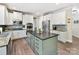Modern kitchen featuring stainless steel appliances, granite counters, stylish island, and bright white cabinets at 250 Kenway Loop, Mooresville, NC 28117