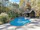 Inviting backyard pool with spacious deck, lush landscaping, and charming pool house, perfect for relaxation at 250 Kenway Loop, Mooresville, NC 28117