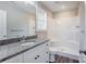 Clean bathroom with granite countertop, white cabinets, and a shower/tub combo at 277 Stewart Nw St, Concord, NC 28027