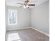 Well-lit bedroom with carpet, ceiling fan and window at 277 Stewart Nw St, Concord, NC 28027