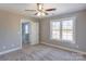 Spacious bedroom featuring carpet, ceiling fan and multiple windows at 277 Stewart Nw St, Concord, NC 28027