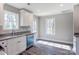 Modern kitchen with white cabinets, granite countertops, and stainless steel appliances at 277 Stewart Nw St, Concord, NC 28027