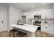 White kitchen island with a quartz countertop and black faucet at 3024 Sadler Woods Ln, Charlotte, NC 28214