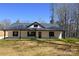 Exterior view of the home featuring black trim, covered porch, and a well-maintained lawn at 3720 Turner Rd, Clover, SC 29710