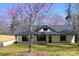 Charming ranch-style home featuring black trim and a blooming tree in the front yard at 3720 Turner Rd, Clover, SC 29710
