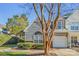 Gray siding townhouse with a white garage door and landscaping at 6078 Bobcat Pl, Charlotte, NC 28269