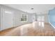 Bright living room featuring hardwood floors and access to the backyard at 6078 Bobcat Pl, Charlotte, NC 28269