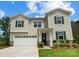 Two-story house with a large white garage and landscaping at 9835 Quercus Ln, Huntersville, NC 28078