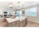 Open concept kitchen with island, farmhouse sink, and view of living room at 9835 Quercus Ln, Huntersville, NC 28078