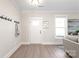 Bright entryway with a coat rack, white door and hardwood floors at 1066 Riverwalk Pkwy, Rock Hill, SC 29730