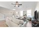 Spacious living room with light-colored sofas, a large TV, and ample natural light at 1066 Riverwalk Pkwy, Rock Hill, SC 29730