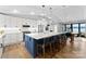 Bright kitchen featuring a white and blue island, stainless steel appliances, and hardwood floors at 111 Breezeview Pl, Mooresville, NC 28117