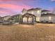 Backyard view at dusk with pergola and firepit at 1265 Reflection Nw Ave, Concord, NC 28027