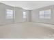 Bright and airy bedroom with neutral walls and plush carpeting at 1265 Reflection Nw Ave, Concord, NC 28027