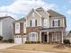 Two-story house with stone accents and a three-car garage at 1265 Reflection Nw Ave, Concord, NC 28027