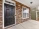 Black front door with stone and white trim at 1265 Reflection Nw Ave, Concord, NC 28027