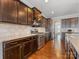 Spacious kitchen with dark wood cabinets and granite countertops at 1265 Reflection Nw Ave, Concord, NC 28027