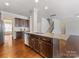 Spacious kitchen with island, stainless steel appliances, and dark wood cabinets at 1265 Reflection Nw Ave, Concord, NC 28027