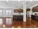 Open kitchen with island, stainless steel appliances, and hardwood floors at 1265 Reflection Nw Ave, Concord, NC 28027