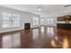 Open living space with hardwood floors, fireplace, and kitchen views at 1265 Reflection Nw Ave, Concord, NC 28027