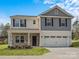 Two-story house with gray and beige siding, two-car garage, and landscaping at 13119 Hamilton Rd, Charlotte, NC 28273