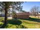 Brick home with a large backyard, covered patio, and mature tree at 1544 Daybreak Ridge Rd, Kannapolis, NC 28081