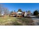 Front view of brick ranch house with driveway and landscaping at 1544 Daybreak Ridge Rd, Kannapolis, NC 28081