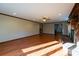 Sunlit living room showcasing hardwood floors and a brick fireplace at 1544 Daybreak Ridge Rd, Kannapolis, NC 28081