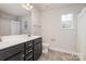 Double vanity bathroom with dark brown cabinets and tile flooring at 159 Charles Farm Dr, Cleveland, NC 27013