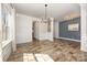 Elegant dining room with wood floors, wainscoting, and a contemporary chandelier at 159 Charles Farm Dr, Cleveland, NC 27013