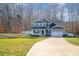 Two-story home with gray siding, a two-car garage, and a landscaped yard at 159 Charles Farm Dr, Cleveland, NC 27013