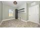 Functional laundry room includes a window, shelving, and space for a washer and dryer at 159 Charles Farm Dr, Cleveland, NC 27013