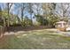 Large backyard with fire pit, wooden fence, and shed at 1814 Archdale Dr, Charlotte, NC 28210