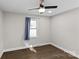 Simple bedroom with hardwood floors and window at 1814 Archdale Dr, Charlotte, NC 28210