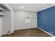 Simple bedroom with dark blue accent wall and hardwood floors at 1814 Archdale Dr, Charlotte, NC 28210