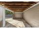 Covered carport with concrete floor and ample space for one car at 1814 Archdale Dr, Charlotte, NC 28210