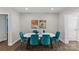 Bright dining area with a white table and teal velvet chairs at 1814 Archdale Dr, Charlotte, NC 28210