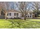 Charming ranch home with brick facade and landscaped lawn at 1814 Archdale Dr, Charlotte, NC 28210