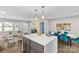 Open concept kitchen and living area with island and seating at 1814 Archdale Dr, Charlotte, NC 28210