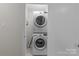 Laundry closet with stackable washer and dryer at 1814 Archdale Dr, Charlotte, NC 28210