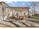 Outdoor patio with seating area, umbrella, and adjacent to house at 1814 Archdale Dr, Charlotte, NC 28210