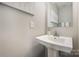 Modern bathroom with pedestal sink and vanity mirror at 1907 Catkin Ln, Charlotte, NC 28205